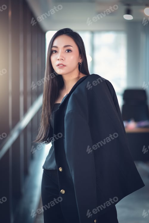 Preview: Confident Beautiful Asian Businesswoman Standing Against Office Background.