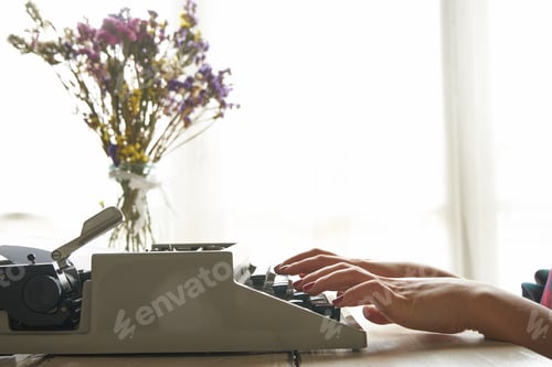 Preview: Girls hands typing in vintage typewriter