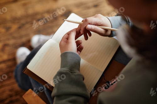 Preview: Woman writing her plans in notebook