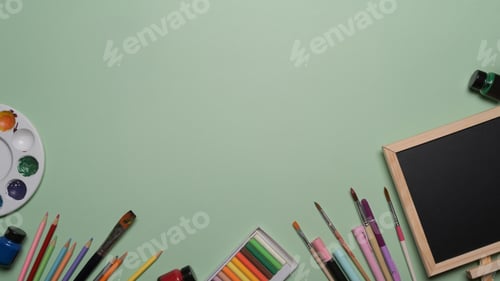 Preview: Chalkboard and school stationery on green background. Back to school concept.
