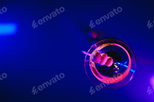 Preview: Martini glass and olives on a black background with neon lights