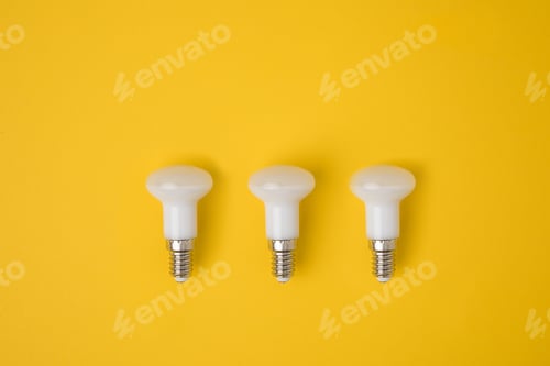 Preview: top view of set of white lamps isolated on yellow