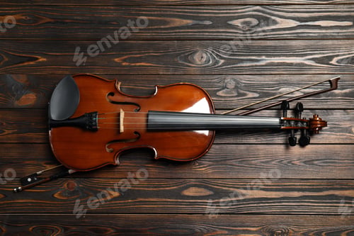 Preview: Classic violin and bow on wooden background, top view