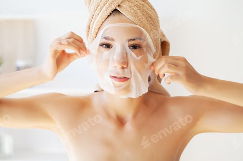 Preview: Pretty girl wearing face care mask at home