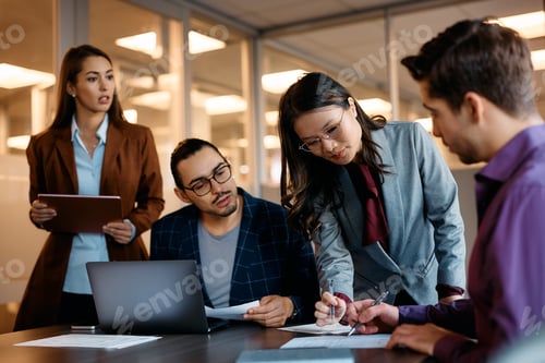 Preview: Happy Asian female CEO having business meeting with her coworkers in the office.