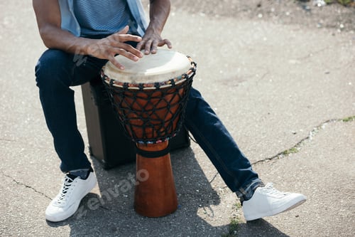 Preview: Cropped view of African american man with djembe performing on street