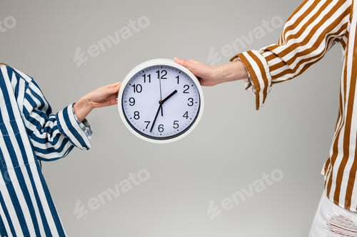 Preview: Round Wall Clock. Women In Oversize Striped Outfits Carrying Plain Wall Clock Between Them With