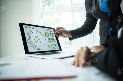 Preview: Close up of business people working with business document during discussion at meeting.