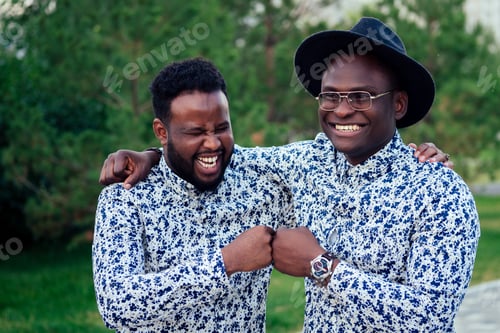 Preview: two black men in stylish suits meeting in a summer park.