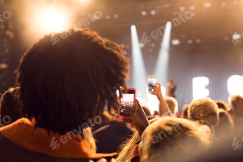 Preview: People using smartphones at music concert