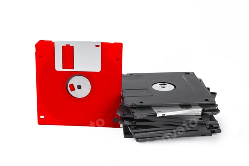 Preview: Old floppy disks stacked on a white surface showing retro technology from the past decades