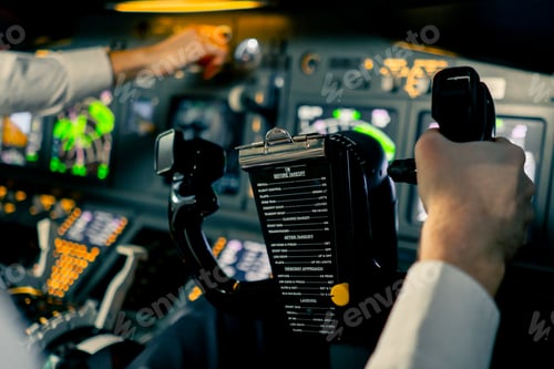 Preview: Pilot in the cockpit of an airplane holding a rotary steering wheel during flight Air travel concept