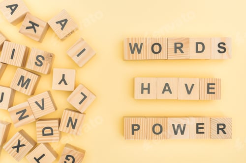 Preview: top view of phrase words have power lettering with wooden cubes on yellow background