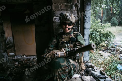 Preview: Close-up of a professional fully equipped soldier looking at camera