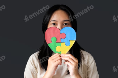 Preview: Girl Holding Puzzle Heart on Gray Background. Child Mental Health Concept.