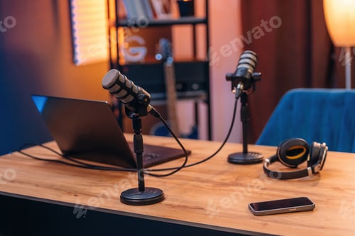 Preview: Microphones, headphones smartphone and laptop are on the table, room for podcasts