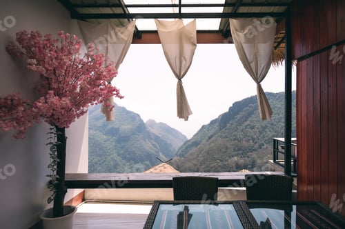 Preview: A room with wooden windows adorned with elegant curtains, featuring a view of the landscape outside