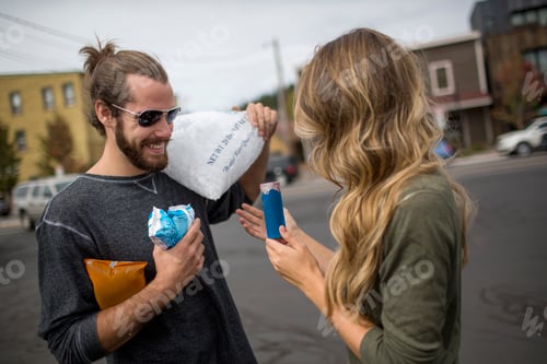 Preview: Young couple carrying provisions for road trip