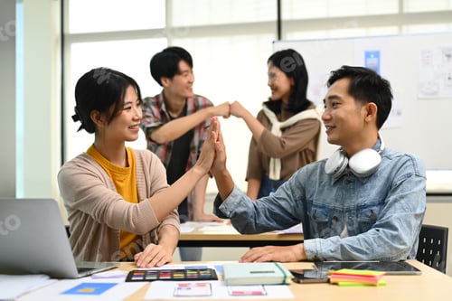Preview: Happy asian female employee giving high five with colleague, celebration for teamwork achievement.