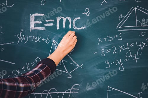 Preview: Teacher or student writing on blackboard during math lesson in school classroom