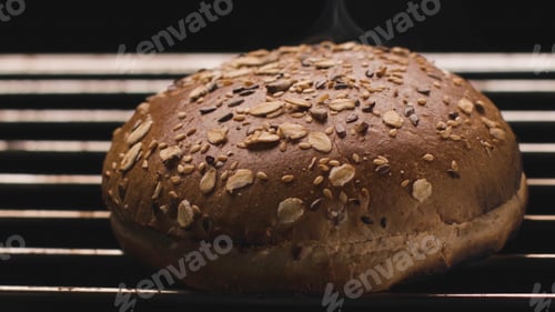 Preview: Close-up of hot Burger bun on grill. Stock footage. Delicious grain bread is grilled. Bun on grill