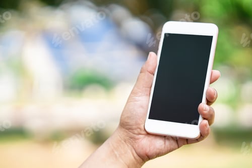 Preview: Holding and use smart mobile phone to communication at outdoor in park.