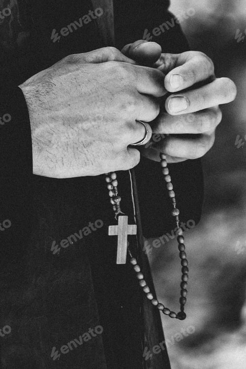 Preview: The priest holds a chain with a cross in his hands