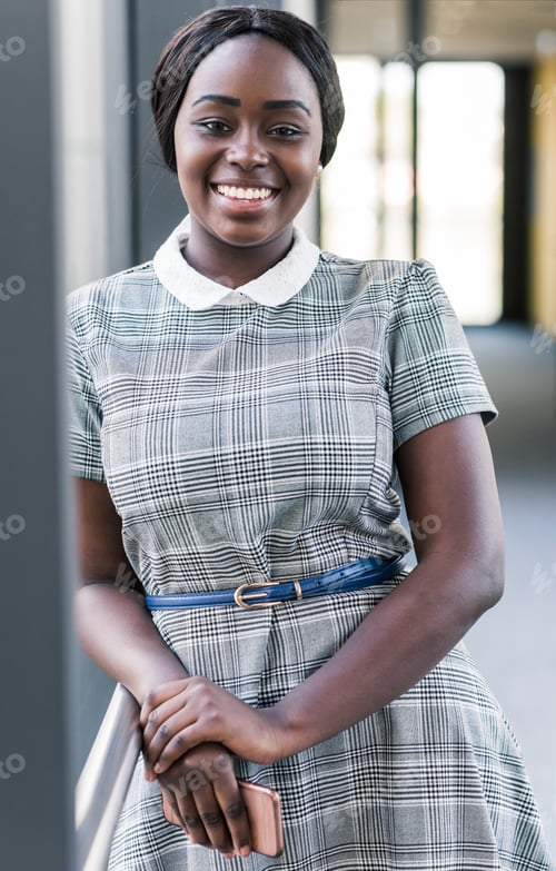Preview: Portrait of smiling young woman on office floor
