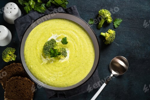 Preview: Broccoli cream soup in the bowl on dark table