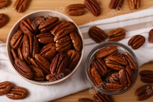 Preview: Tasty pecan nuts on wooden table, above view