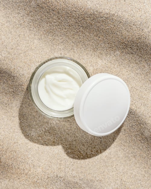 Preview: Opened cream jar with white lid on beige sand top view, hard light. Cosmetic mockup