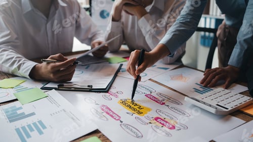 Preview: Meeting of hardworking businesspeople work together as a team by presenting graphs. and charting the