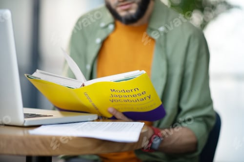 Preview: Businessman studying foreign languages sitting at the table