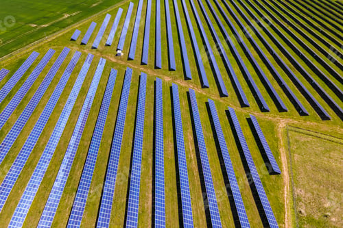 Preview: Aerial view of big sustainable electric power plant with many rows of solar photovoltaic panels for
