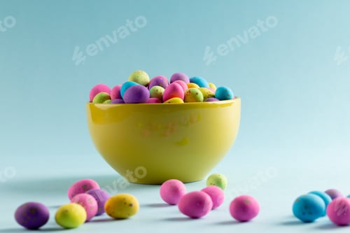 Preview: Image of multi coloured easter eggs in bowl with copy space on blue background