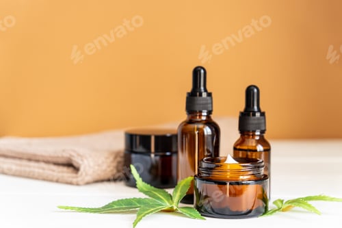 Preview: Cannabis face cream or serum or oil dropper concept. Natural cosmetic. CBD oil, THC tincture and hem