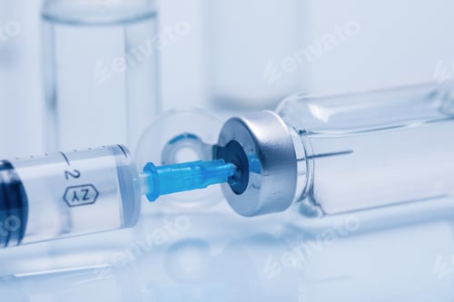Preview: Closeup of glass medicine vials with liquid and a syringe