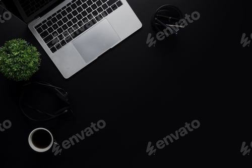 Preview: top view of dark and black table with laptop and business office supply working