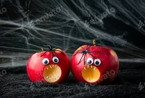 Preview: Halloween background.Scary apples with spiders on a dark background. Halloween food. Copy space.