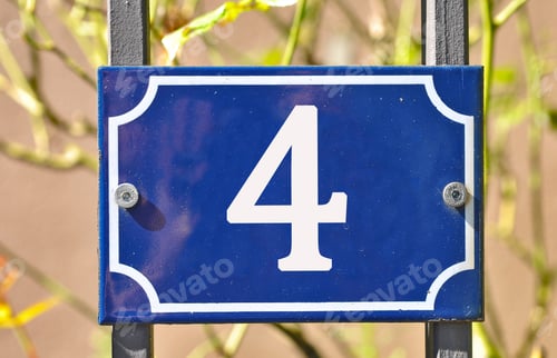 Preview: Closeup shot of a blue sign with the number 4 on the blurry background