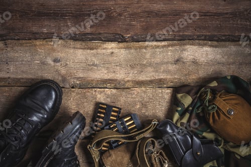 Preview: Army military uniform, weapon, holster, pistol, flask, boots on wooden background. Flat lay top view