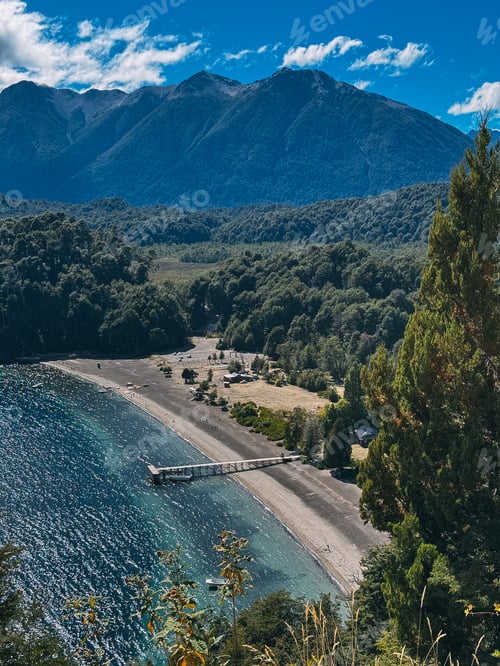 Preview: A beautiful beach with a dock and a mountain in the background