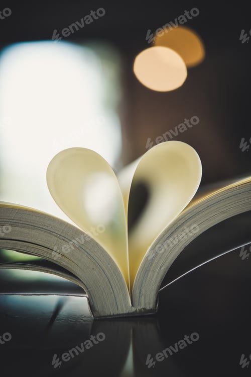 Preview: Curled paper heart shape with blurred bokeh of cafe.