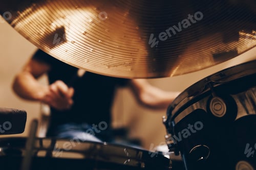 Preview: Man with headphones playing on drums