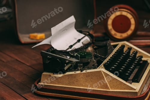 Preview: vintage typewriter for printing white sheet of paper wooden background retro invention