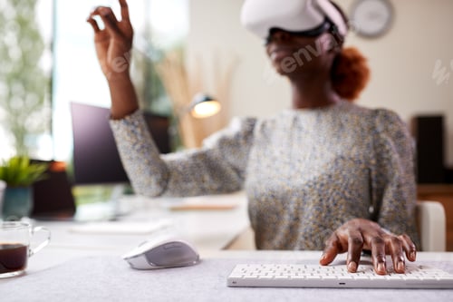 Preview: Woman Working From Home Office Sitting At Desk Wearing VR Headset Interacting With AR Technology