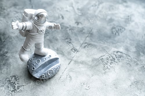 Preview: Astronaut Figurine Standing on Moon with Grey Background