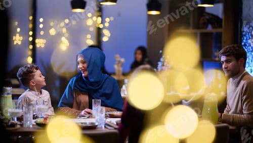 Preview: In a modern restaurant, an Islamic couple and their children joyfully await their iftar meal during
