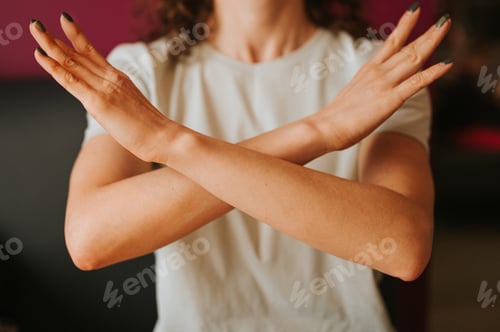 Preview: woman arms crossed demonstrates break the bias symbol iwd women's international day feminism 8 march