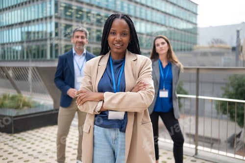 Preview: A diverse business team with the leader at the helm smiles confidently